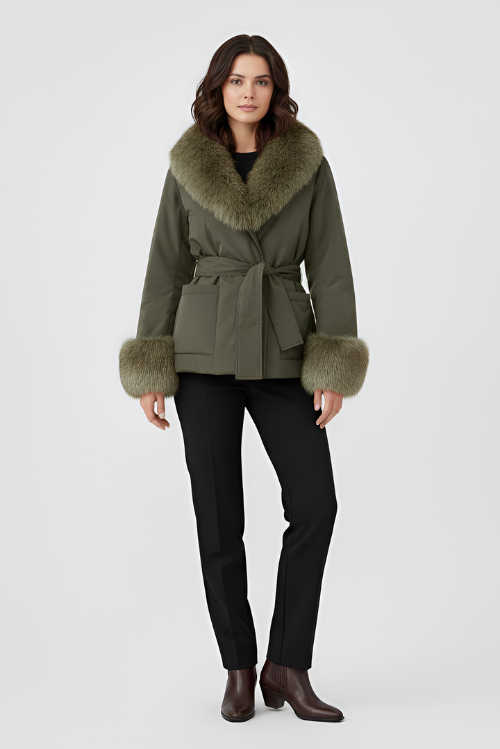 Woman wearing a green coat with fur trim on a white background