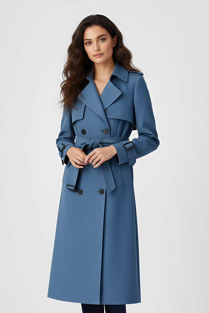 Woman wearing a long blue coat on a white background