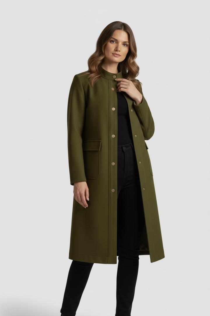 Woman wearing a long olive green coat on a white background