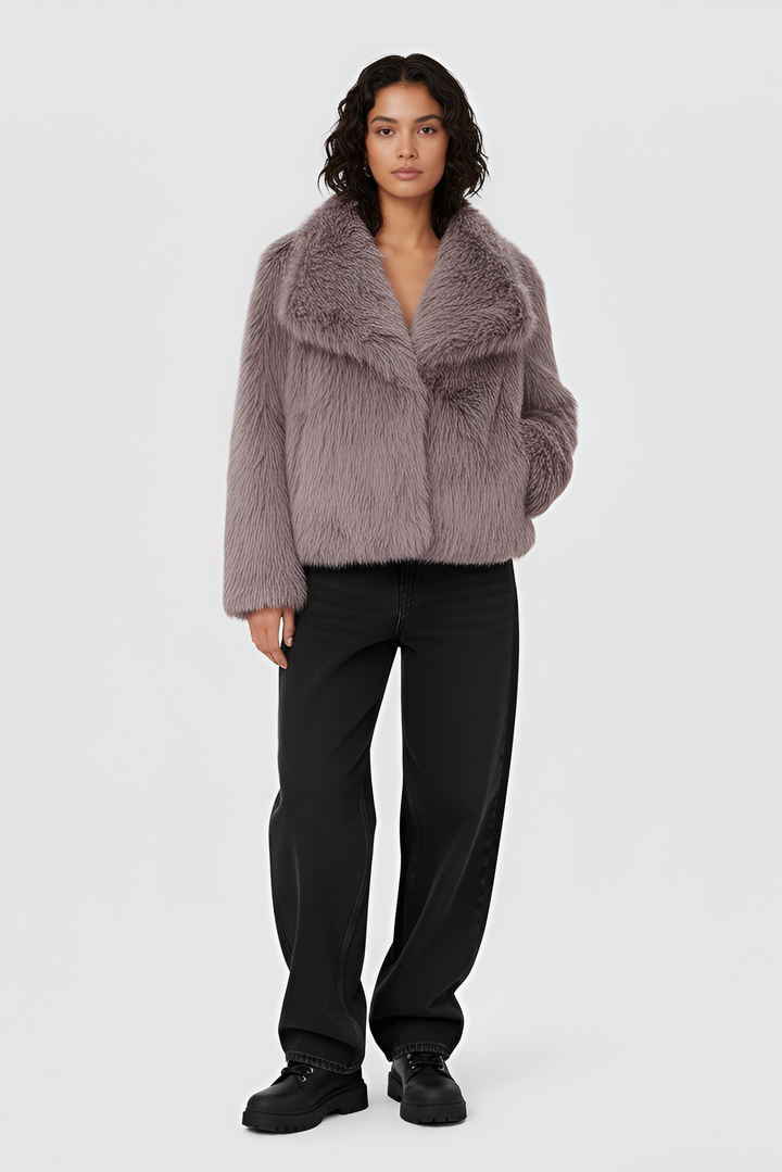 Woman wearing a pink fur coat, white top, and skirt on a plain background