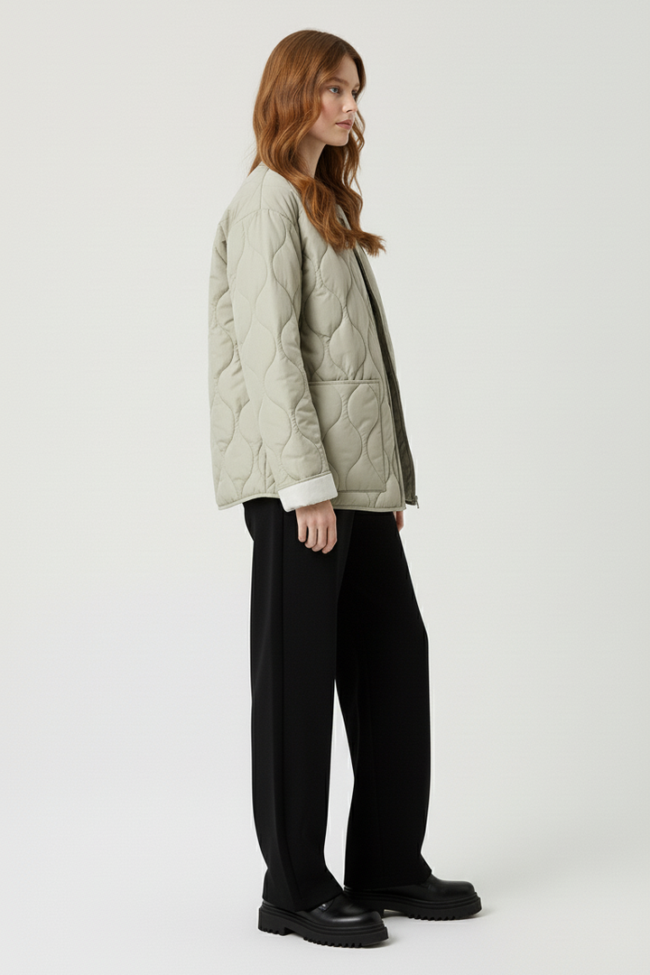 Woman wearing a quilted jacket on a white background