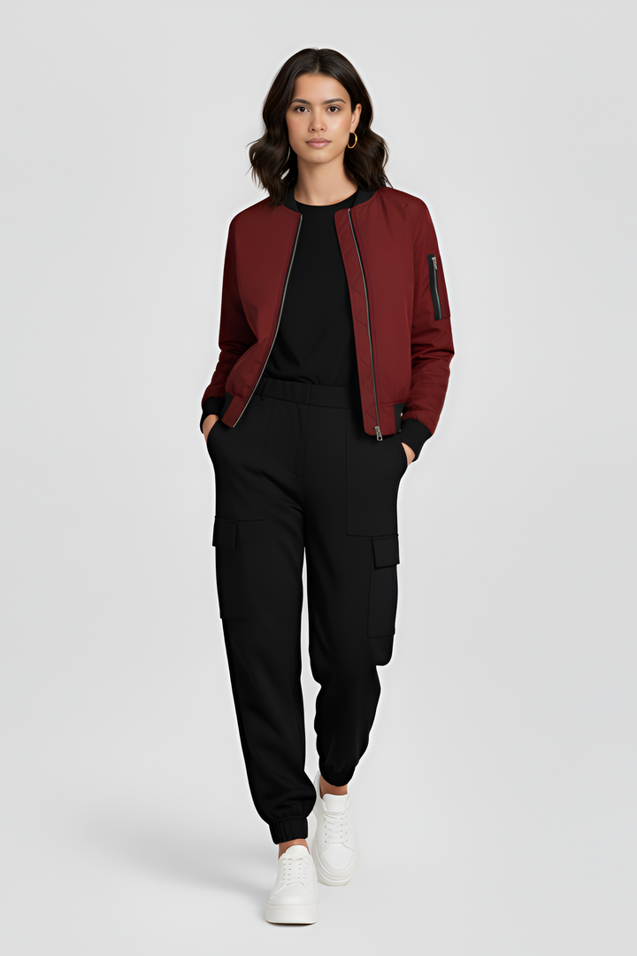 Woman wearing a red jacket and black pants on a white background