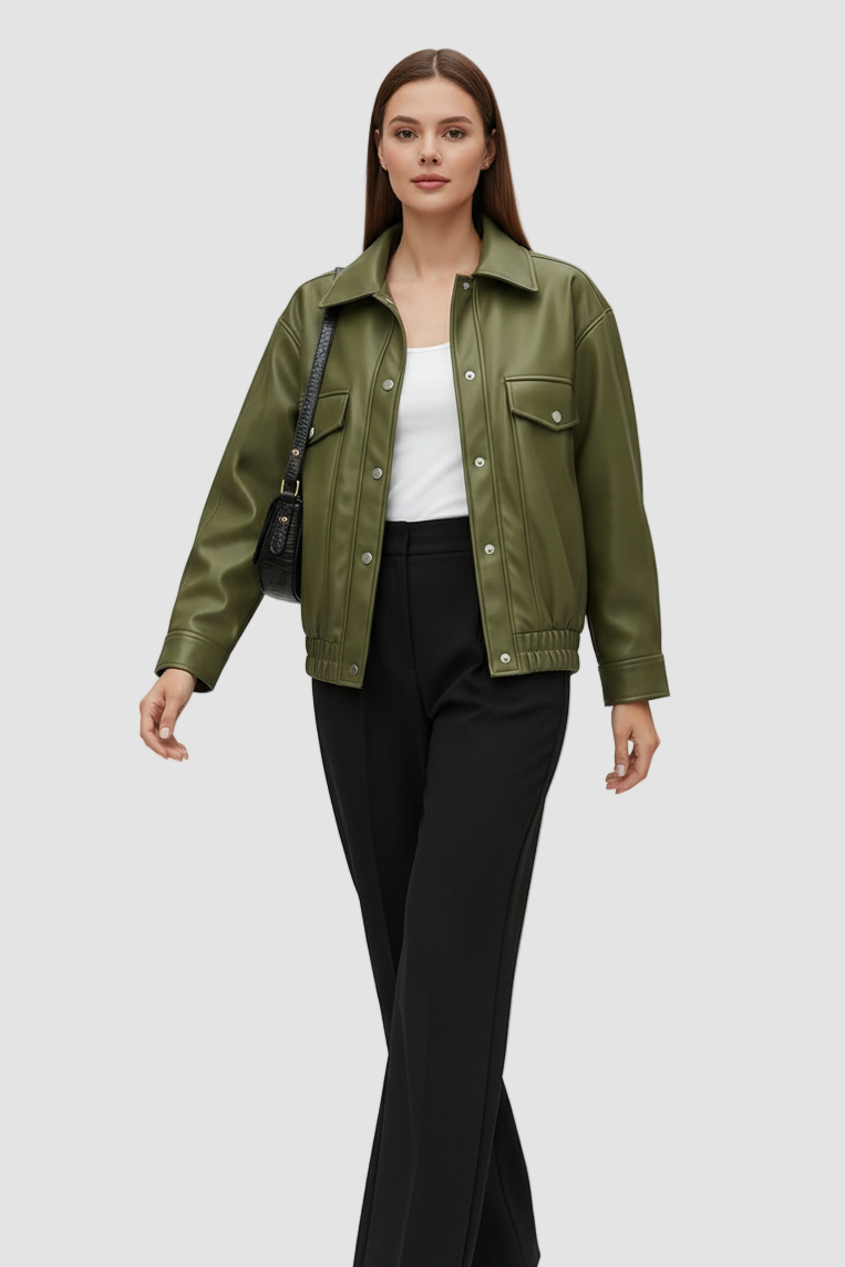 Woman wearing an olive green jacket, white top, and black pants on a light gray background