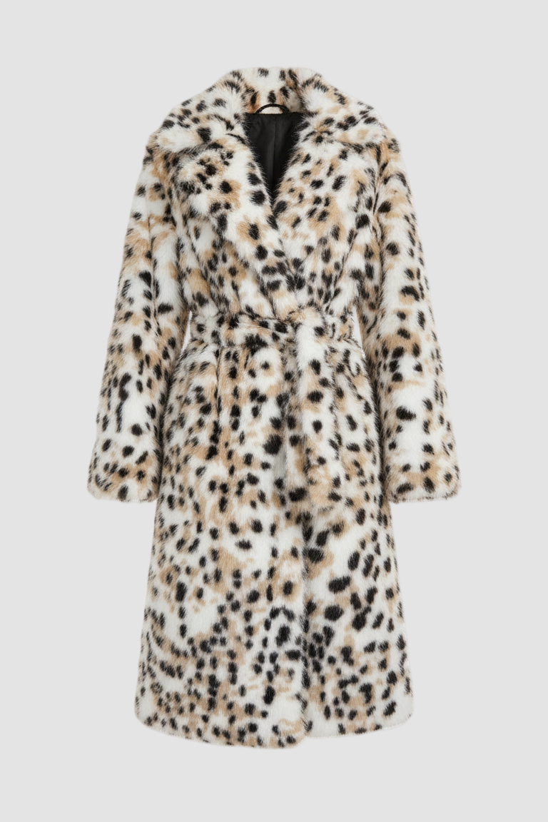 Woman wearing the LYSERRA Leopard Shearling Coat walking outdoors in a winter city setting