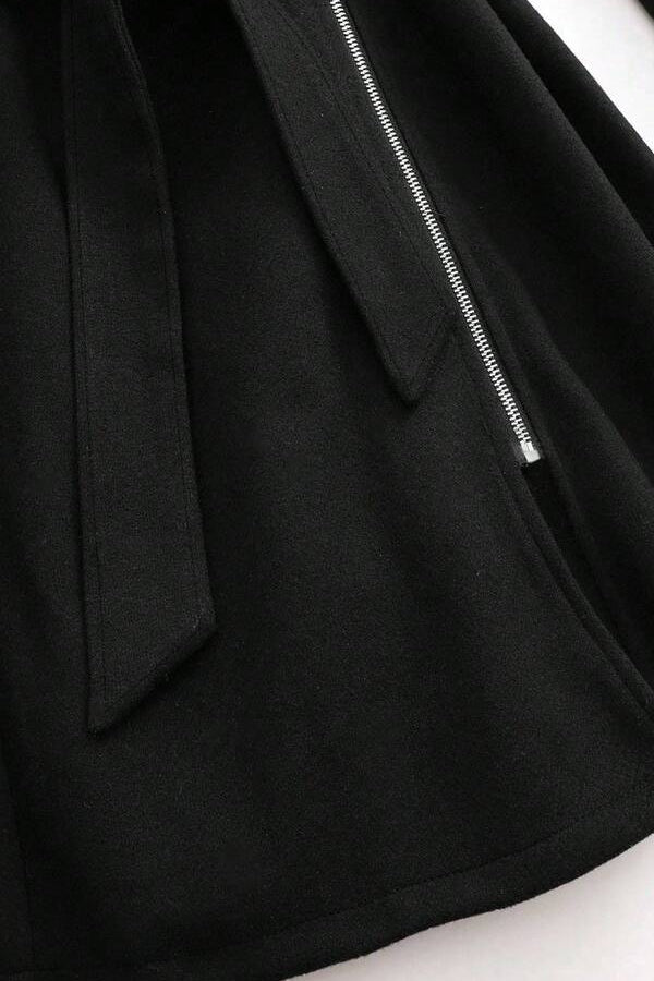 Model styling LEONA Wool Blend Long Coat with chic all-black outfit for modern elegance.