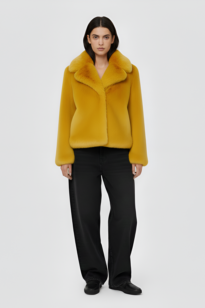 Yellow fur coat on a white background