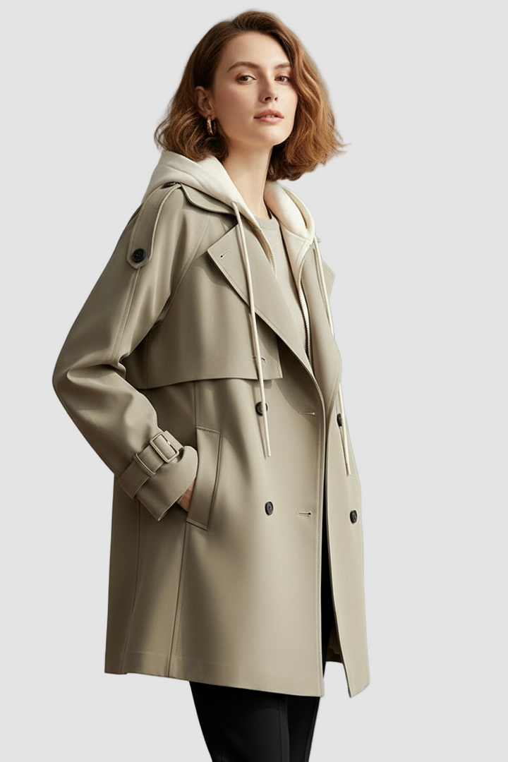 Woman wearing a beige trench coat on a plain background