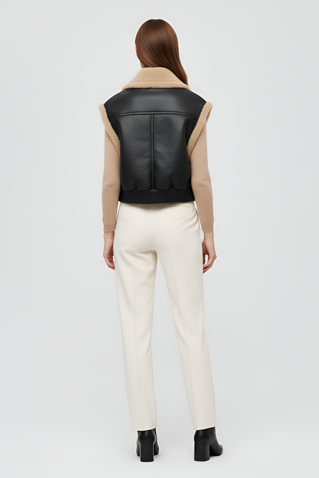 black faux leather vest with plush shearling lining and ribbed hem modern women winterwear