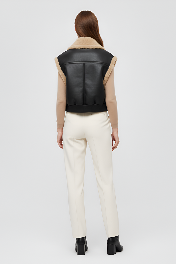 black faux leather vest with plush shearling lining and ribbed hem modern women winterwear
