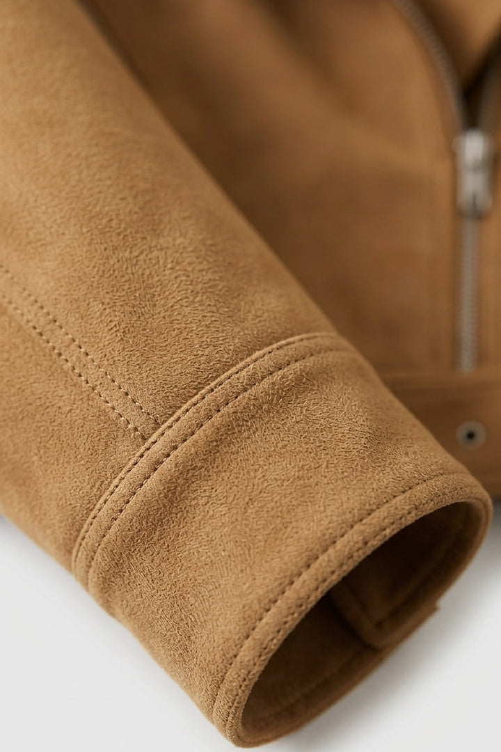 Close-up of a brown fleece jacket sleeve on a white background