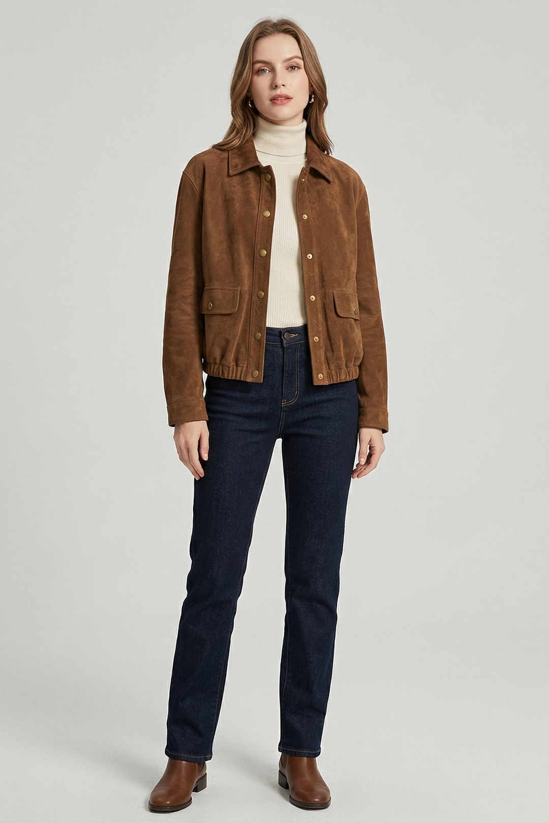 KENDALL - Woman wearing a brown suede bomber jacket over a cream turtleneck and dark jeans, front view