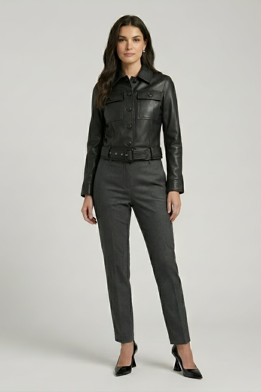 Kenzie - Full shot, woman wearing black leather jacket, grey trousers, heels