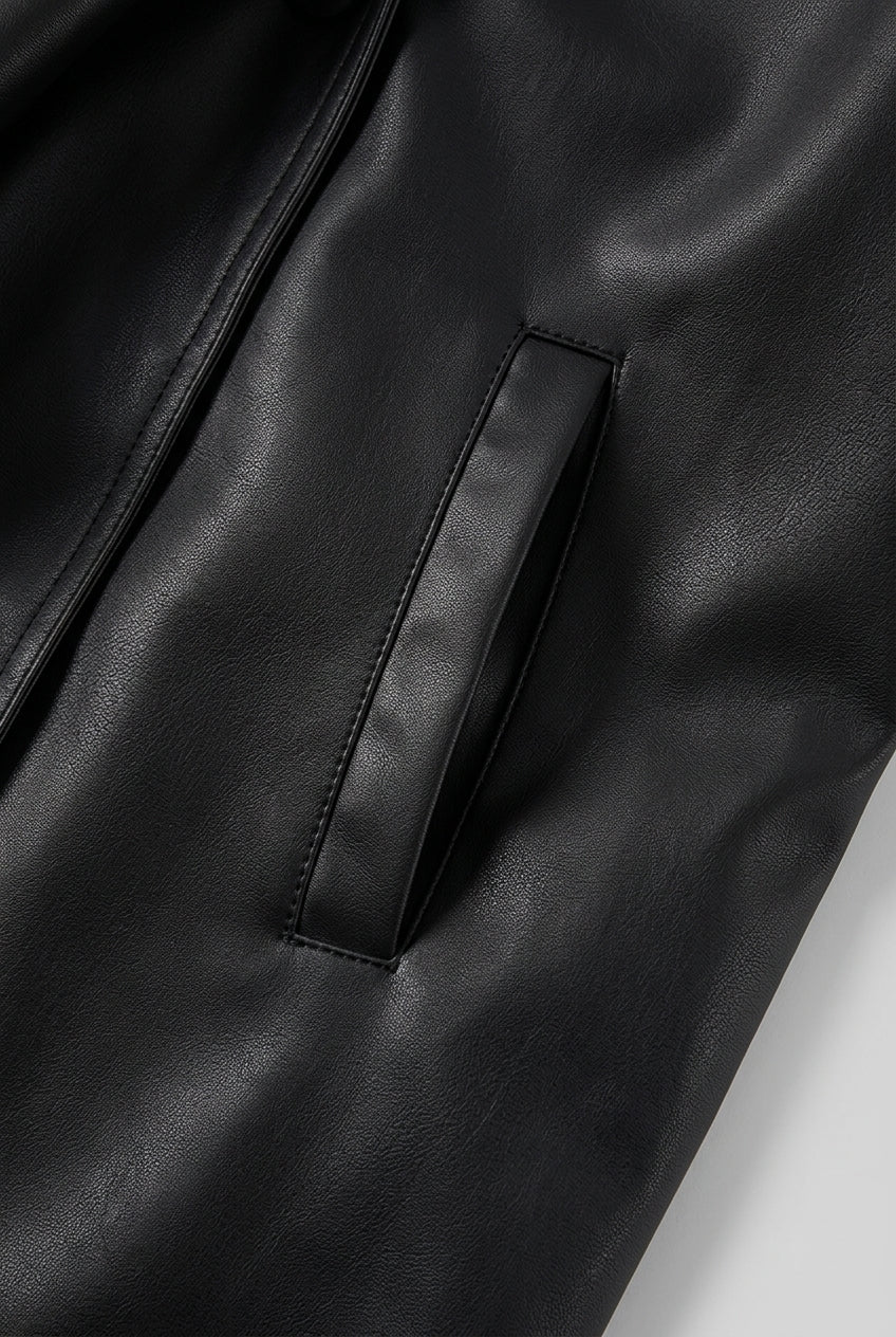 Close-up of the welt pocket on the front panel on the DELANEY fur trim faux leather trench coat