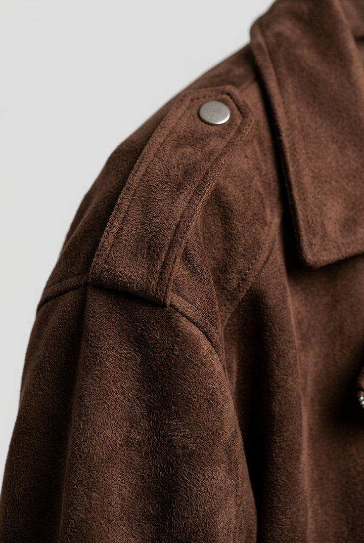 Close-up of the shoulder epaulette with its snap and the brushed suede texture on the FLORA oversized suede biker jacket