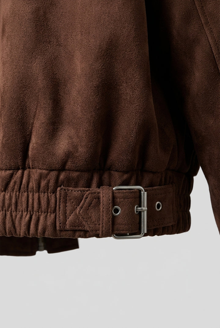 Close-up of the hem band with its buckled tab and metal hardware on the FLORA oversized suede biker jacket