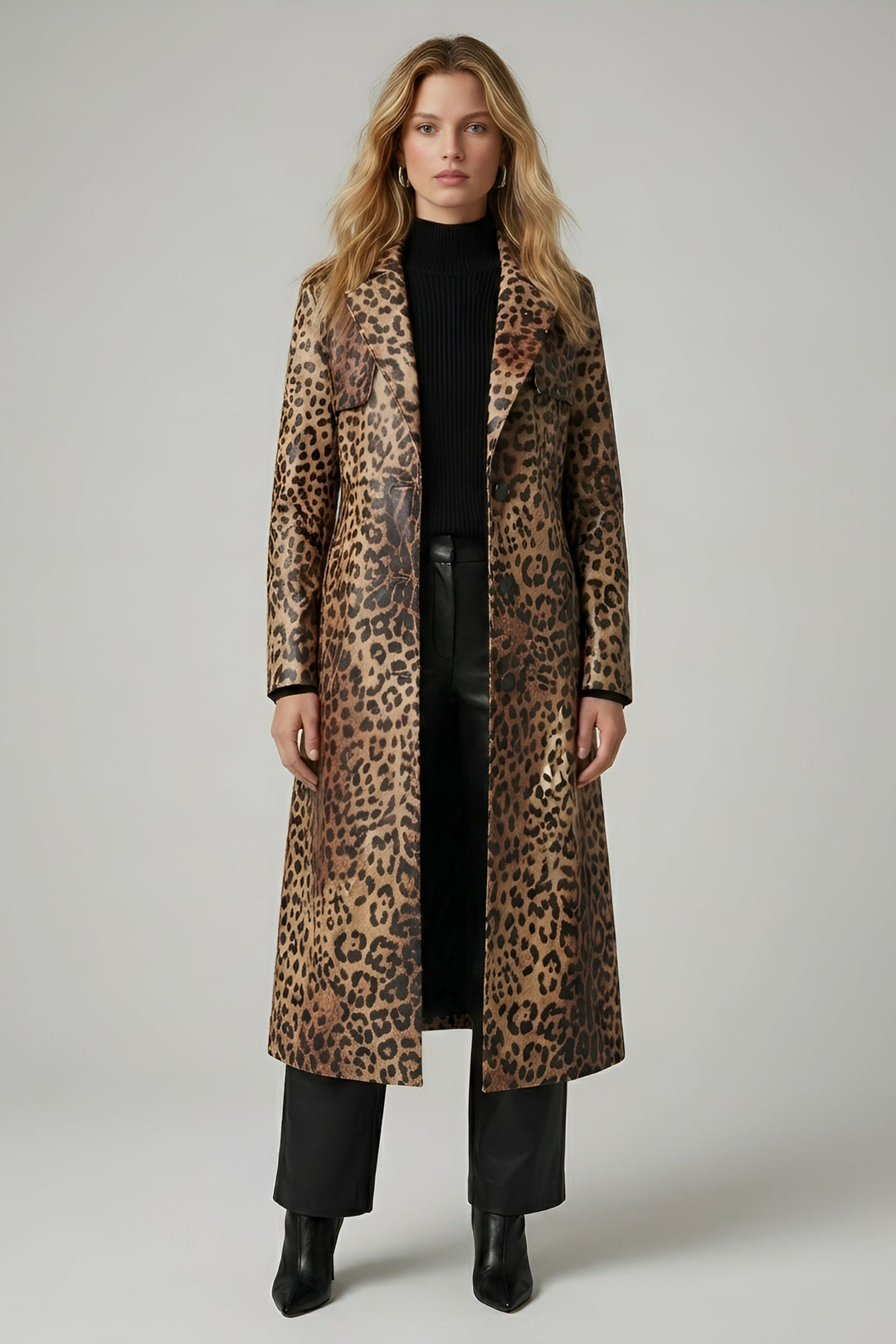 Woman wearing a leopard print coat on a plain background