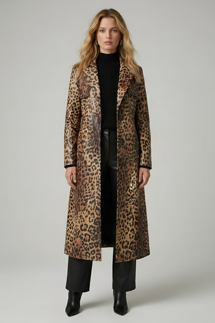 Woman wearing a leopard print coat on a plain background