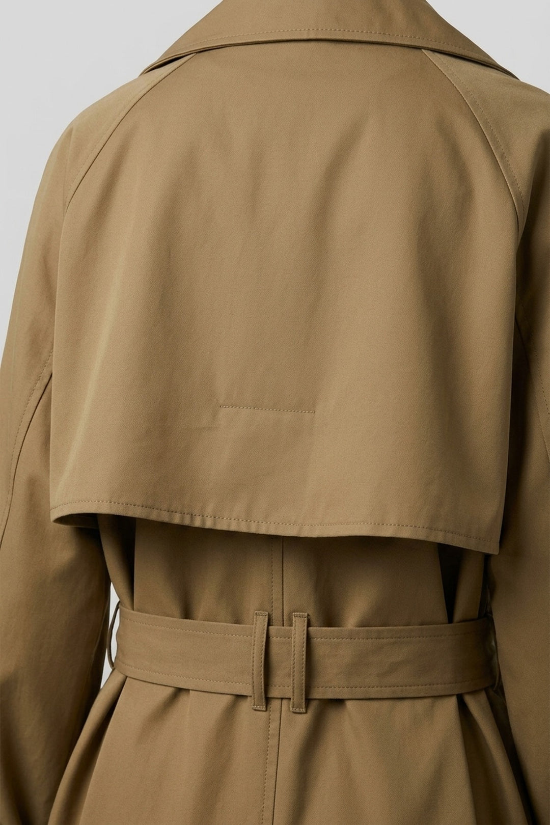 Close-up of the back storm yoke and belt loops on the MEREDITH trench coat