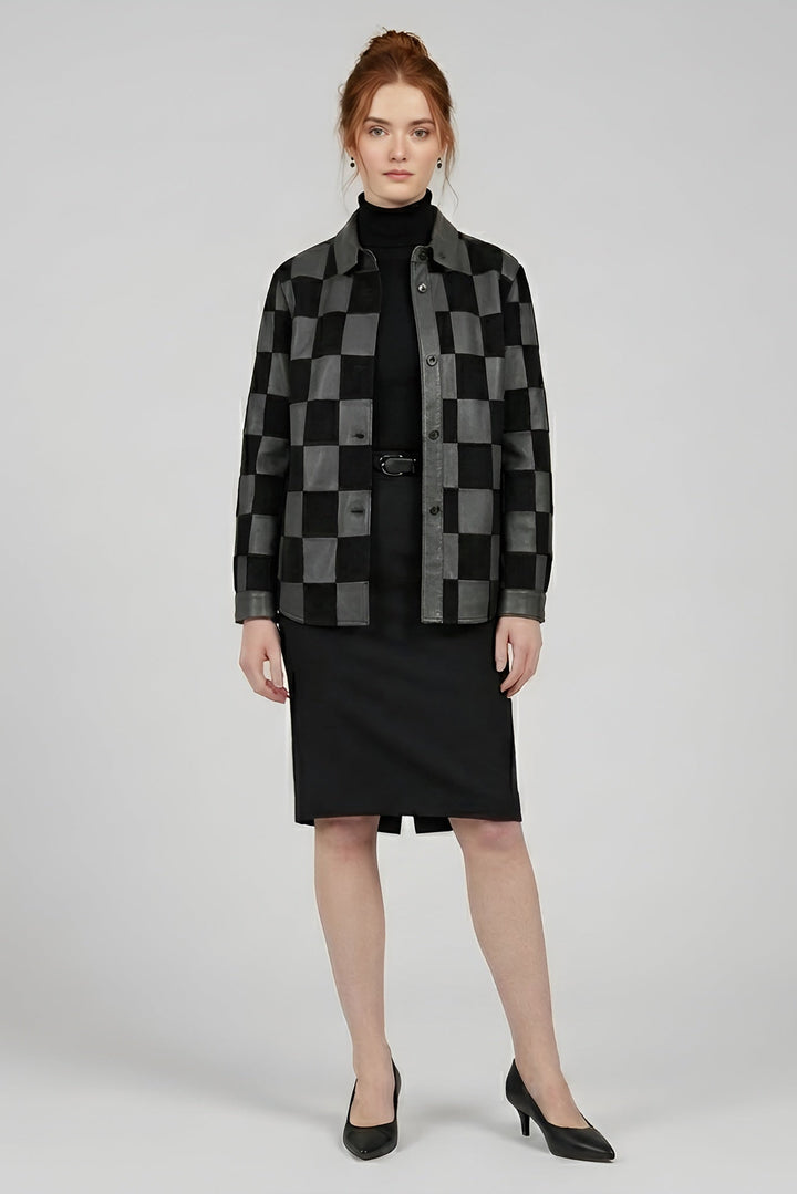 Woman wearing a black and gray checkered jacket with a black skirt on a white background