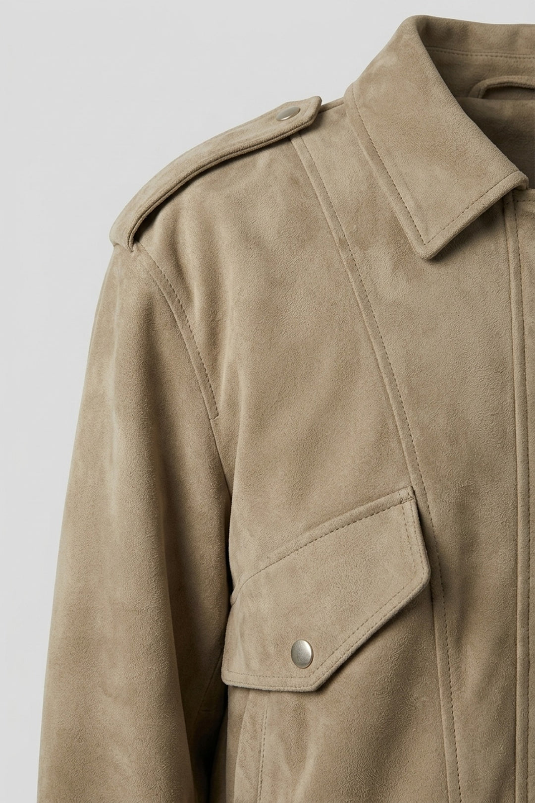 Close-up of the snap flap chest pocket, collar and shoulder tab on the ODETTE suede bomber jacket