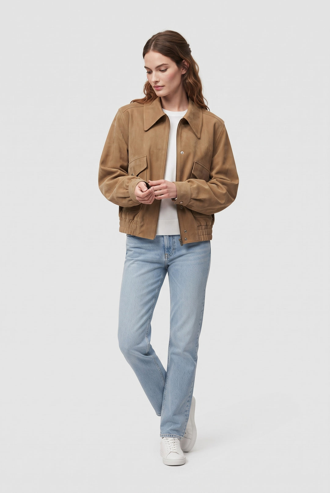 Full-length look: ODETTE khaki suede bomber jacket styled with light-wash jeans and white sneakers