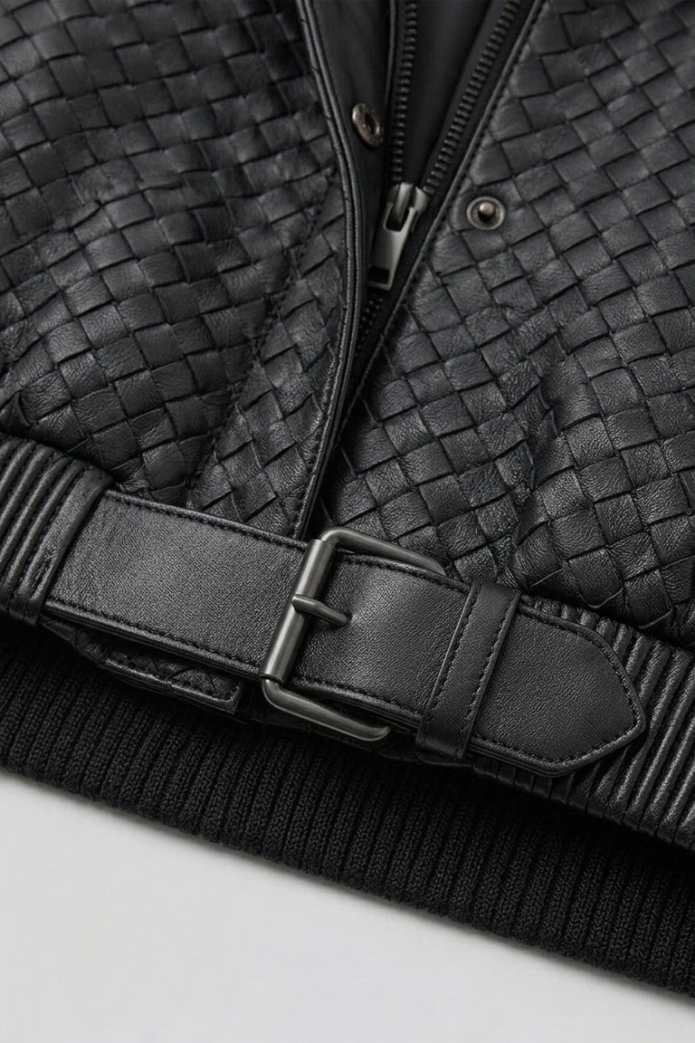 Black woven jacket with a belt on a light gray background