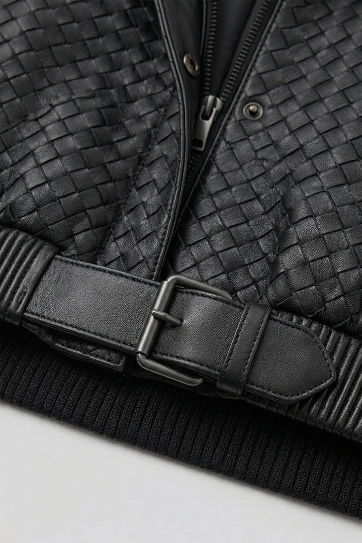 Black woven jacket with a belt on a light gray background